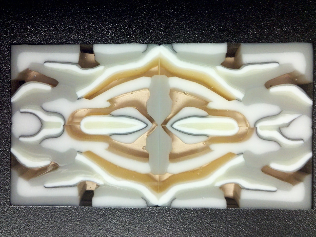 Pattern Bar finished piece — symmetrical white and gold fused glass panel with intricate mirrored organic shapes.